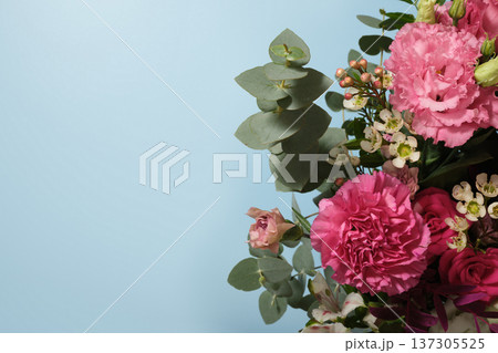 Elegant bouquet with pink carnation, eustoma, roses and eucalyptus on soft blue background with copy space Elegant bouquet with pink carnation, eustoma, roses and eucalyptus on soft blue background with copy space 137305525