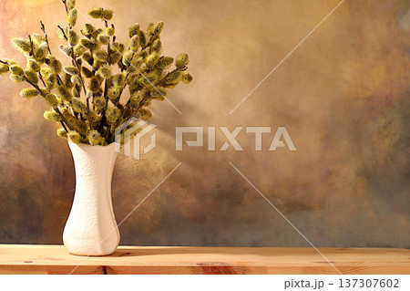 Delicate willow branches in a vase on an elegant kitchen table, abstract spring floral arrangement. Easter card and still life, design template with space for text and a festive Easter banner, Delicate willow branches in a vase on an elegant kitchen table, abstract spring floral arrangement. Easter card and still life, design template with space for text and a festive Easter banner, 137307602