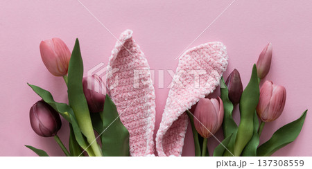 Easter  Knitted  Bunny Ears with Pink Tulips on Pink Background. Spring Holiday Flat Lay 137308559