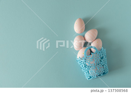 Basket with Pastel Pink Easter Eggs on Blue Background. Minimal Festive Composition Basket with Pastel Pink Easter Eggs on Blue Background. Minimal Festive Composition 137308568
