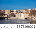 Lyon, france. December 27, 2023. Lyon city featuring historic architecture, riverbank buildings, and a bridge spanning the saone river under a clear blue sky 137309001