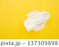 Women's sanitary napkin on a yellow background close-up 137309898
