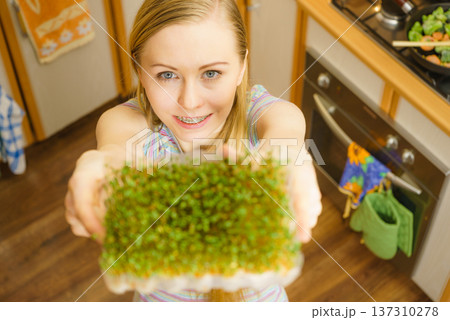 Happy woman holding cuckooflower cress Happy woman holding cuckooflower cress 137310278
