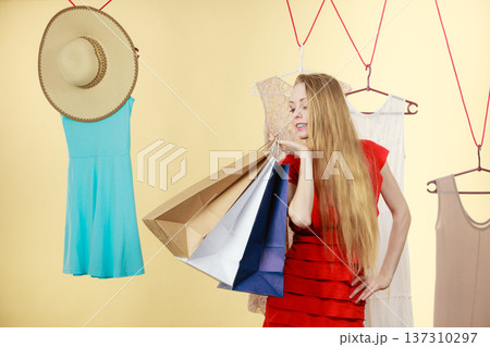 Woman in shop picking clothes, sale concept 137310297