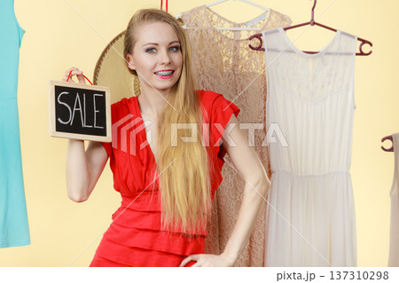 Woman in shop picking clothes, sale concept 137310298