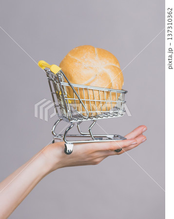 Woman holding shopping cart with bread 137310362