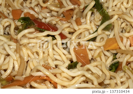 A Close up of delicious fried noodles dinner with vegetables A Close up of delicious fried noodles dinner with vegetables 137310434