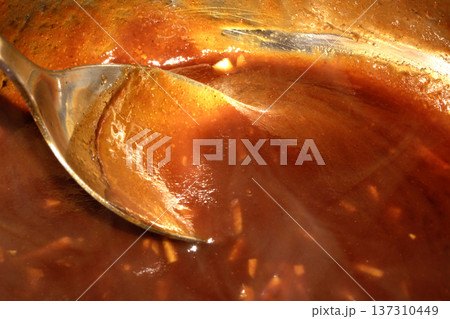 Close up of sweet and sour red sauce being cooked 137310449