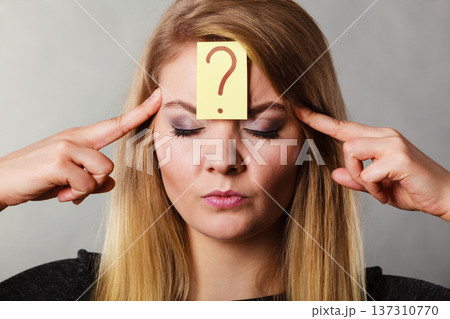 Woman having question mark on forehead Woman having question mark on forehead 137310770