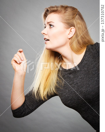 Blonde woman running somewhere profile view 137310782