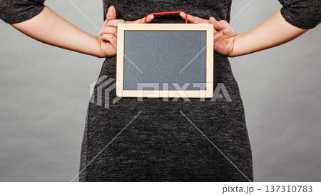 Woman holding blank black board on back Woman holding blank black board on back 137310783