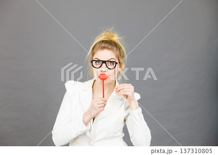 Happy elegant woman holding carnival accessoies on stick 137310805
