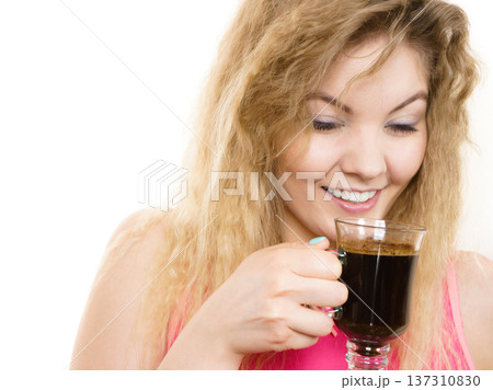 Positive woman drinking her morning coffee Positive woman drinking her morning coffee 137310830
