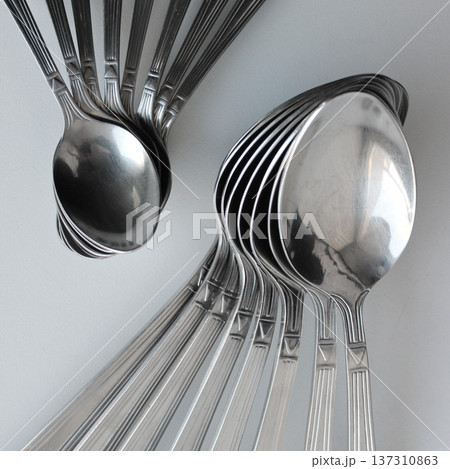 Different Size Spoons Laid Out In Form Of Fan On A Clean Plastic Cutting Board Closeup View 137310863