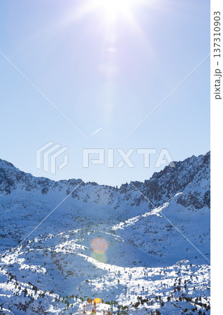 Sunny winter mountain landscape with snow covered peaks and clear blue sky Sunny winter mountain landscape with snow covered peaks and clear blue sky 137310903