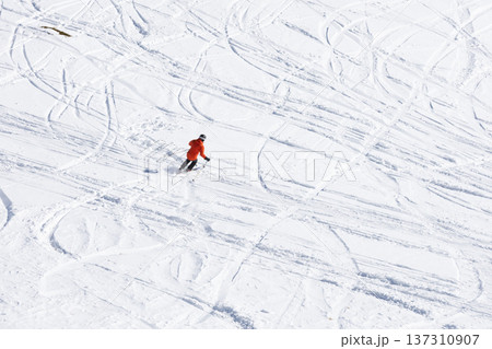 Skiing adventure on snowy mountain with tracks 137310907