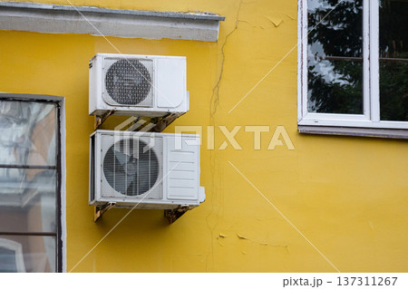 air conditioning on facade of building, air cooling in hot weather. air conditioning on facade of building, air cooling in hot weather. 137311267