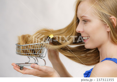 Girl with her long hair in shopping cart Girl with her long hair in shopping cart 137311355