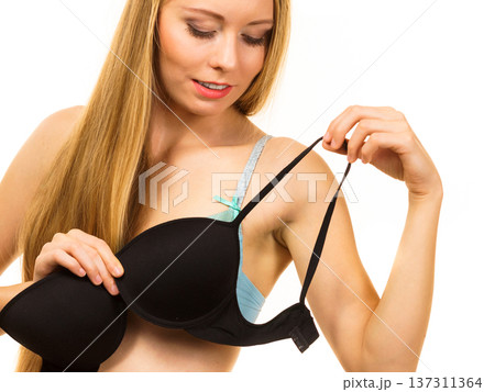 Woman trying on black bra 137311364