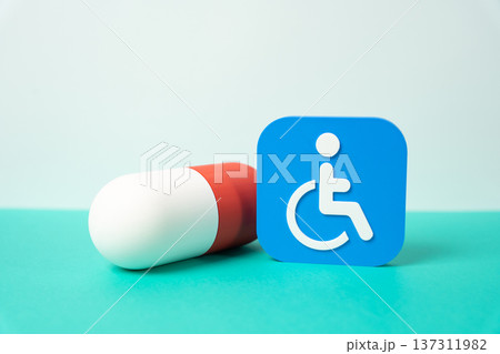 A medicinal capsule and a symbol of a person with a disability. Accessible medications for vulnerable groups and inclusive healthcare support for people with special needs. A medicinal capsule and a symbol of a person with a disability. Accessible medications for vulnerable groups and inclusive healthcare support for people with special needs. 137311982