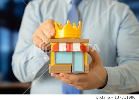 A man places a crown on a store. Best business first place award symbolizing retail leadership market dominance and entrepreneurial success. A man places a crown on a store. Best business first place award symbolizing retail leadership market dominance and entrepreneurial success. 137311996