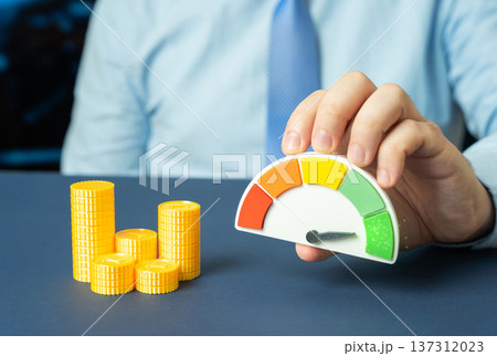 Money and a performance scale showing green. High liquidity and sufficient funds for purchase goals with positive account balance and financial stability. Money and a performance scale showing green. High liquidity and sufficient funds for purchase goals with positive account balance and financial stability. 137312023