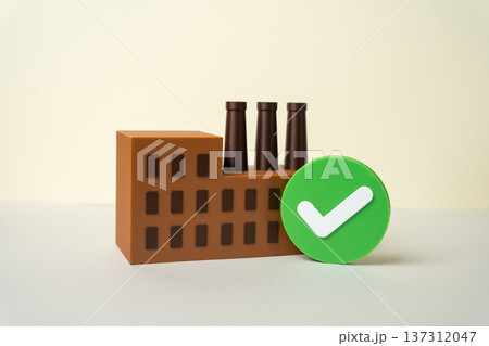 A factory with a green checkmark. The industrial plant has passed the inspection. Environmental standards are met. Sustainable production and eco compliance certification in manufacturing sector 137312047
