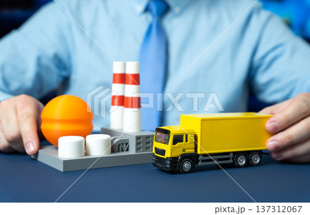 A businessman organizes the transportation of products and raw materials to an industrial plant. Industrial logistics supply chain coordination and procurement management for efficient production. 137312067