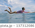 Woman Balances On Ocean Surf, Serene Scene Of Woman Paddling 137312086