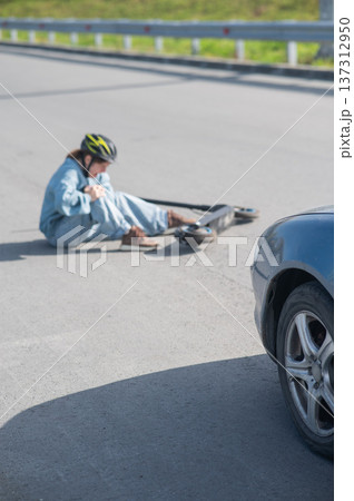 A Caucasian woman on a scooter after being hit by a car. A Caucasian woman on a scooter after being hit by a car. 137312950