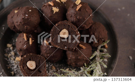 Dark chocolate truffles with hazelnuts Dark chocolate truffles with hazelnuts 137313604