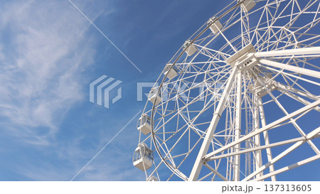White ferris wheel against a clear blue sky 137313605