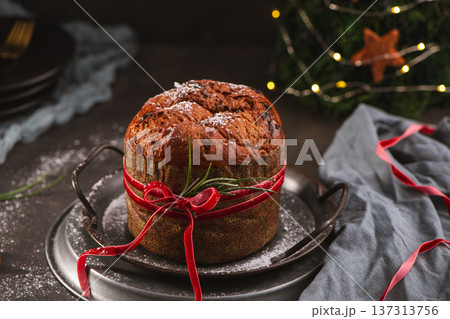 Panettone Cake with Red Ribbon and Christmas Atmosphere Panettone Cake with Red Ribbon and Christmas Atmosphere 137313756