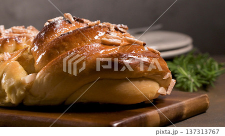 Glossy Sweet Braided Bread with Sliced Almonds and Powdered Sugar Glossy Sweet Braided Bread with Sliced Almonds and Powdered Sugar 137313767