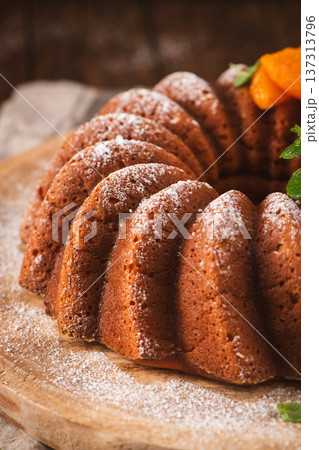 Freshly Baked Bundt Cake with Powdered Sugar and Apricot Garnish 137313796