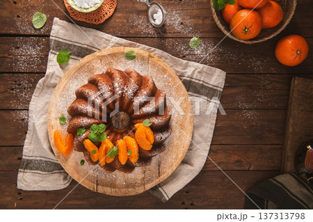 Mandarin Orange Bundt Cake with Powdered Sugar on a Rustic Wooden Table Mandarin Orange Bundt Cake with Powdered Sugar on a Rustic Wooden Table 137313798