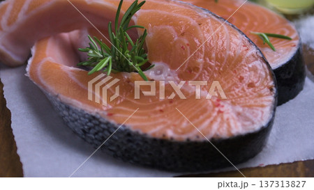 Fresh Raw Salmon Steak with Rosemary and Spices on Parchment Paper Fresh Raw Salmon Steak with Rosemary and Spices on Parchment Paper 137313827