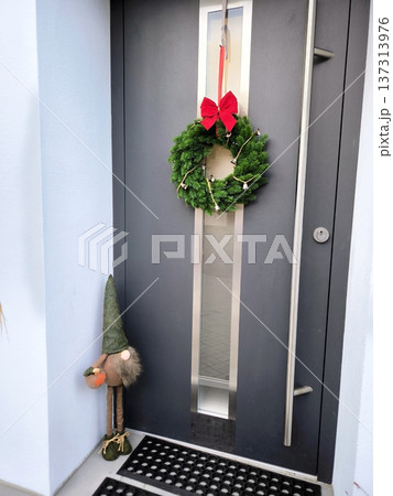 Modern front door with Christmas wreath and decorative gnome Modern front door with Christmas wreath and decorative gnome 137313976