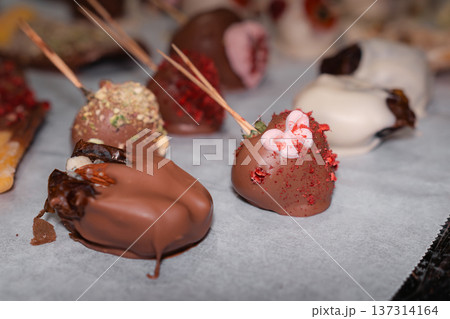 Chocolate Covered Strawberries With Assorted Toppings on Baking Paper 137314164