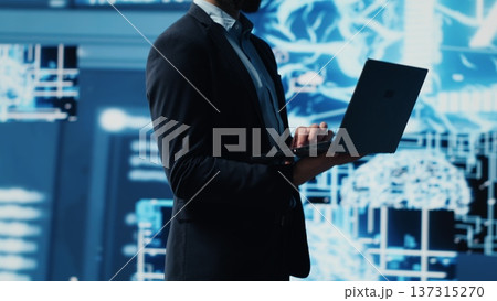 Young entrepreneur reviewing predictive analytics and machine learning algorithms. The digital interface reflects innovation, coding, AI ethics and platforms transformation. Camera A. Young entrepreneur reviewing predictive analytics and machine learning algorithms. The digital interface reflects innovation, coding, AI ethics and platforms transformation. Camera A. 137315270