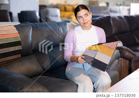 girl on the sofa infurniture store decides what fabric to choose girl on the sofa infurniture store decides what fabric to choose 137318030