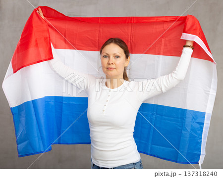 Attractive female football fan holding Netherlands flag Attractive female football fan holding Netherlands flag 137318240