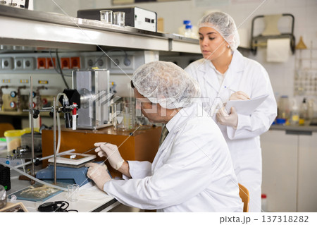 Confident man technician working in research laboratory Confident man technician working in research laboratory 137318282