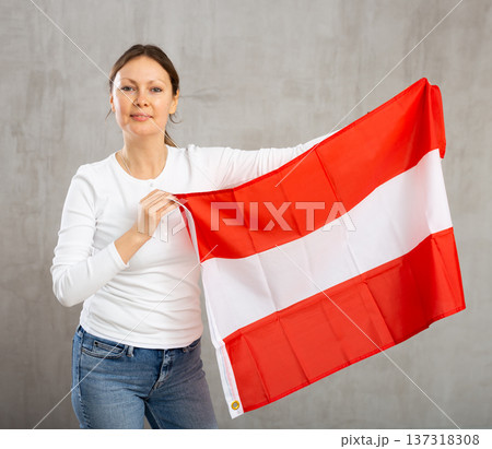 Adult cheerful woman holding Austrian flag 137318308