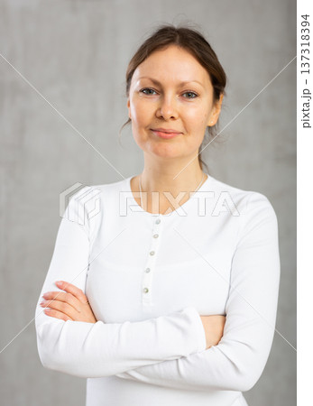 Portrait of smiling adult woman posing in studio Portrait of smiling adult woman posing in studio 137318394