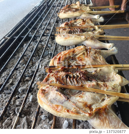 Grilled chicken street food charcoal bamboo skewer outdoor cooking Asian cuisine savors juicy smoky flavor 137320877