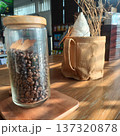 Coffee bean glass jar wooden lid natural light rustic decor cozy cafe interior with warm atmosphere 137320878