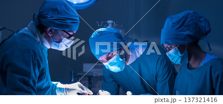 Group of concentrated surgical doctor team doing surgery patients in hospital operating theater. Professional medical team doing critical operations. Group of concentrated surgical doctor team doing surgery patients in hospital operating theater. Professional medical team doing critical operations. 137321416