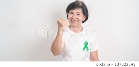 Elderly with Green Ribbon for concept of April Donate Life month, Organ Donation and Transplant Awareness, May Mental Health Awareness month and October Liver cancer. Health and world cancer day Elderly with Green Ribbon for concept of April Donate Life month, Organ Donation and Transplant Awareness, May Mental Health Awareness month and October Liver cancer. Health and world cancer day 137322345