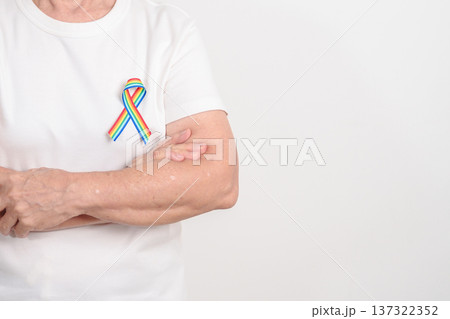 Elderly with LGBTQ Rainbow ribbon for concept of June Pride month, April Autism Awareness, All cancer Awareness, February World Cancer day, October World Hospice and Palliative care day and Survivor 137322352